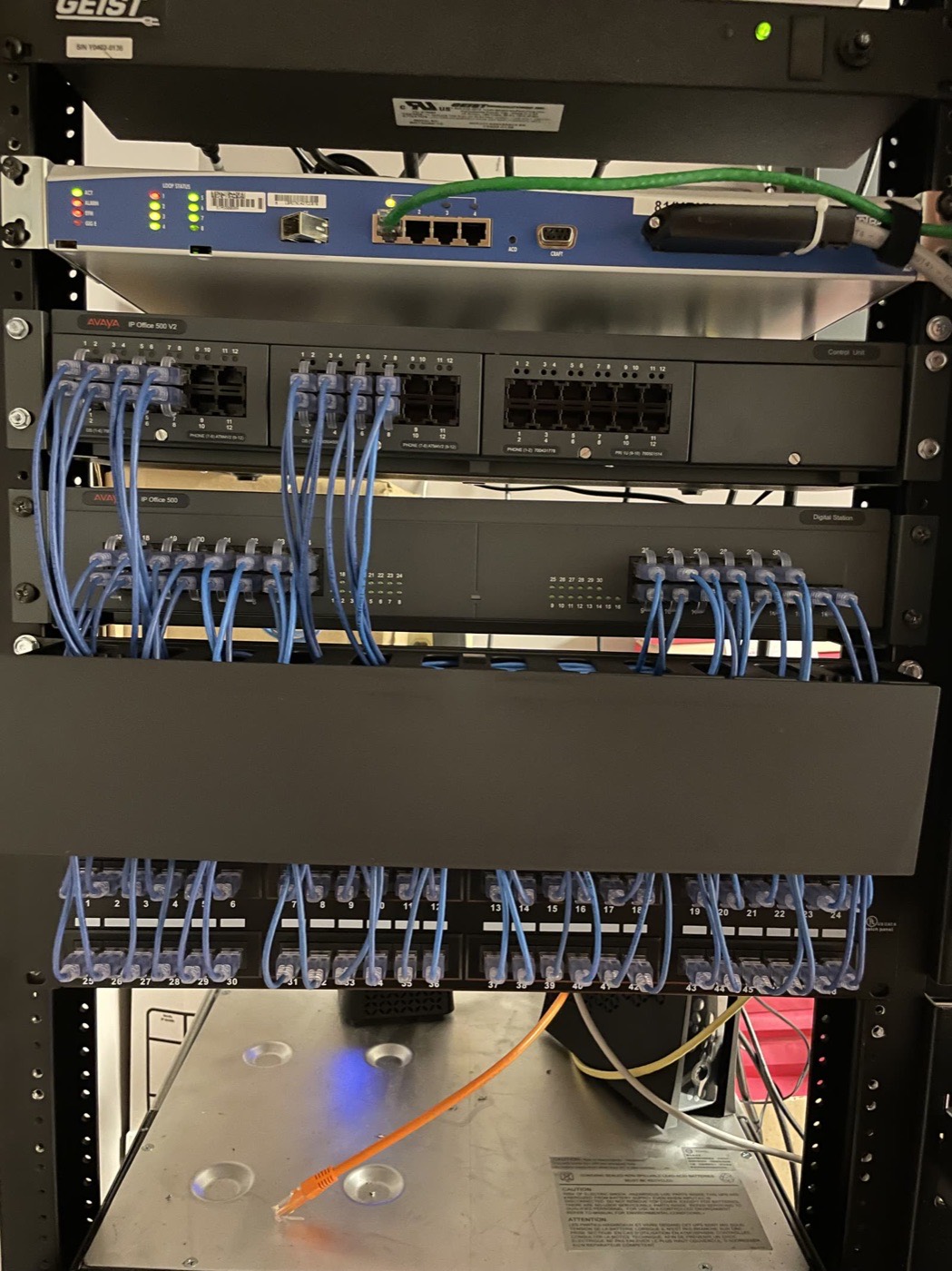 Business phone system with neatly looped patch cords into the panel